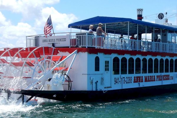 A red and white paddlewheel riverboat named 